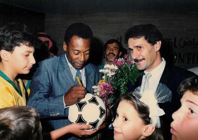 Pelé signing the ball